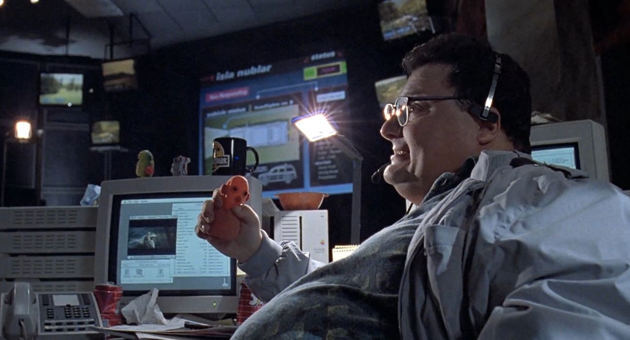 Image from Jurassic Park (1993) of Dennis Nedry (Wayne Knight) squeezing a stress ball and saying, 'Thanks, Dad.'